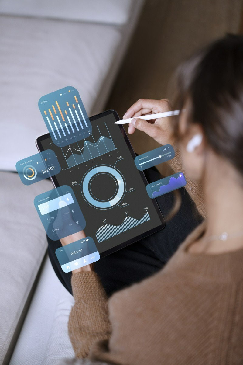 Person reviewing a CRM dashboard with sales statistics on a tablet
